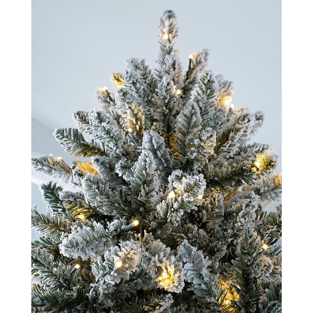 A 7-foot pre-lit full-body snow-planted Christmas tree with LED lights that chase warmth